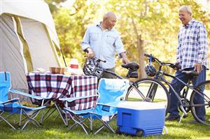 2 men at campsite with bicycles